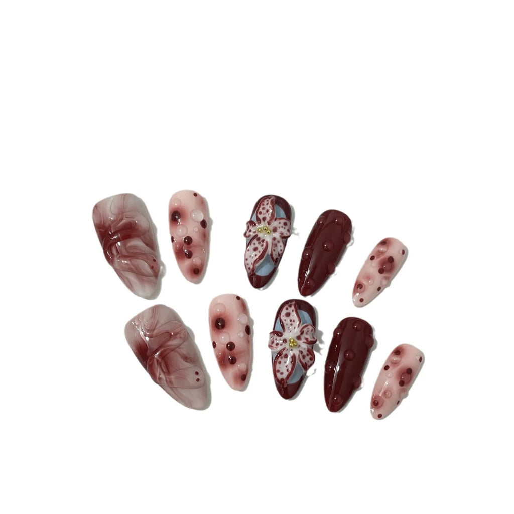 Hand-painted three-dimensional carved acrylic manicure nails in almond colour with floral and geometric patterns