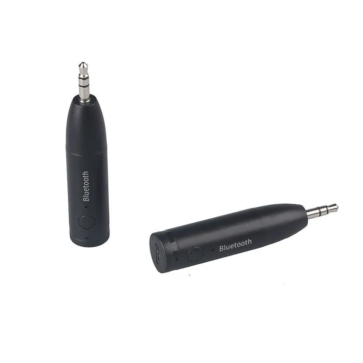 Black AUX Bluetooth 5.0 audio receiver for car stereo with USB cable.