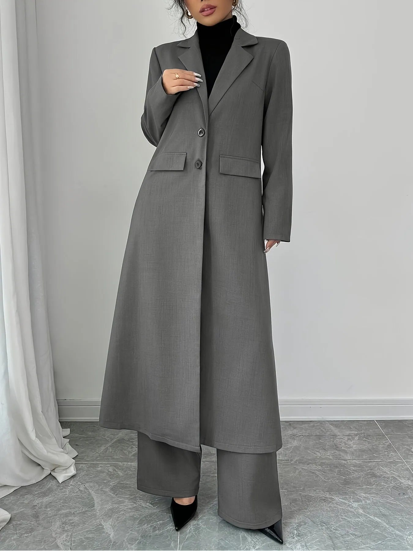 Women's gray polyester two-piece suit with long jacket and trousers on mannequin