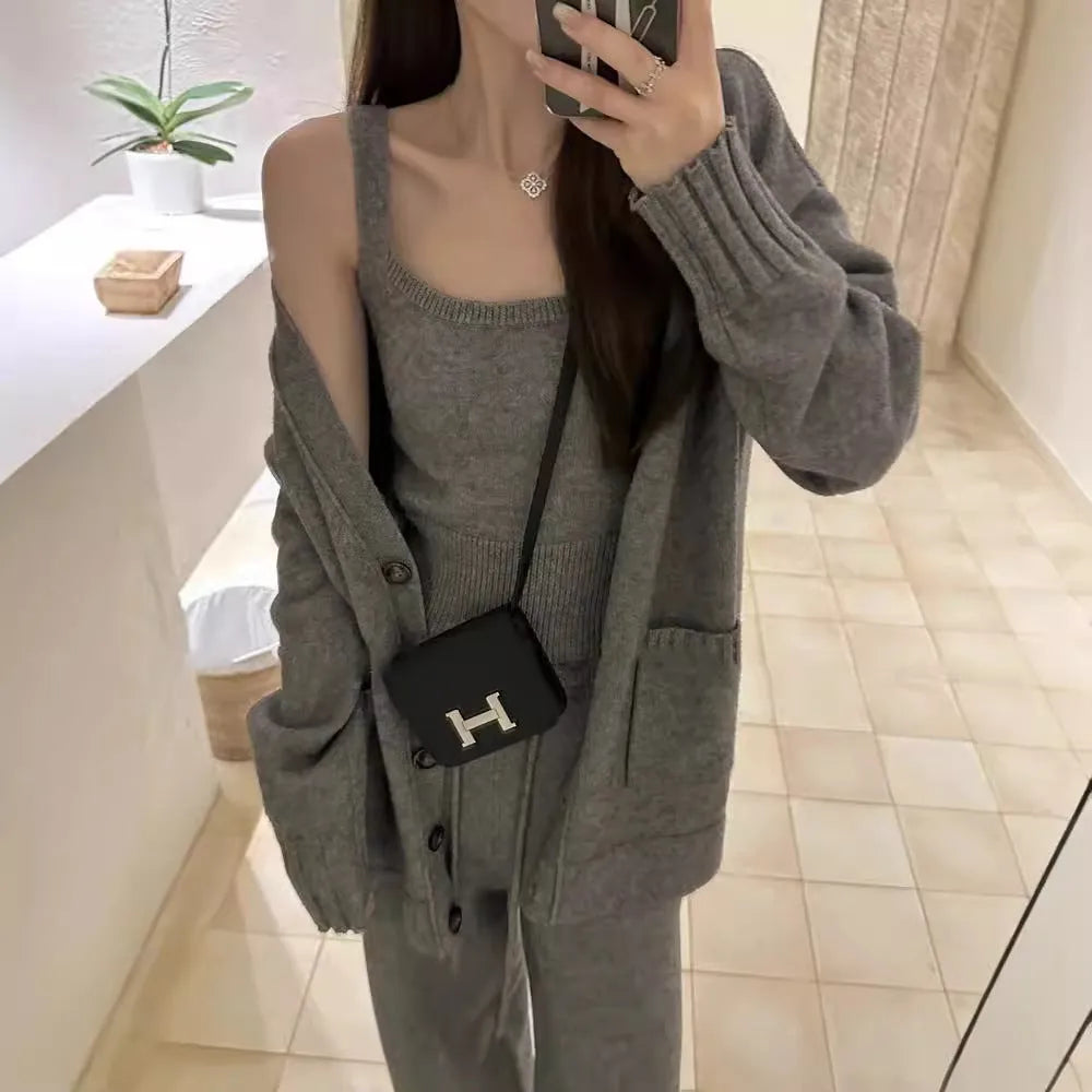 Women's light brown knit cardigan and suspender pants three-piece casual set on a hanger.
