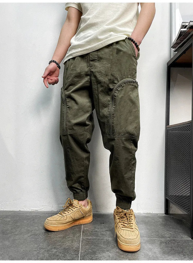 Men's loose-fit cotton cargo trousers with elastic waist, zipper, and multiple big pockets in army green