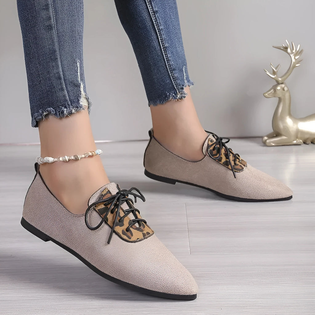 Beige leopard print women's pointed toe pumps on a white background, side view.