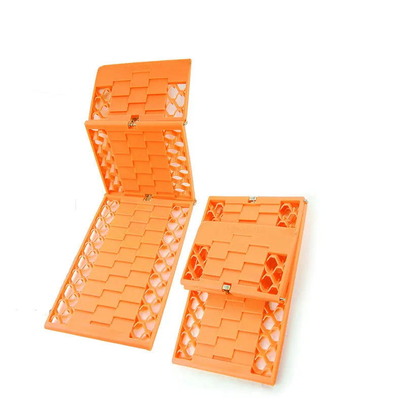 Orange folding rescue boards for vehicle recovery in mud and snow conditions