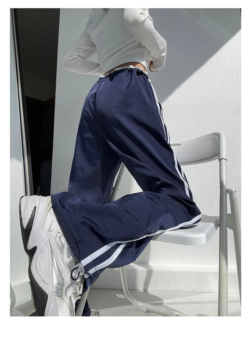 Navy blue and white loose straight leg trousers with ribbon parallel bars detail.