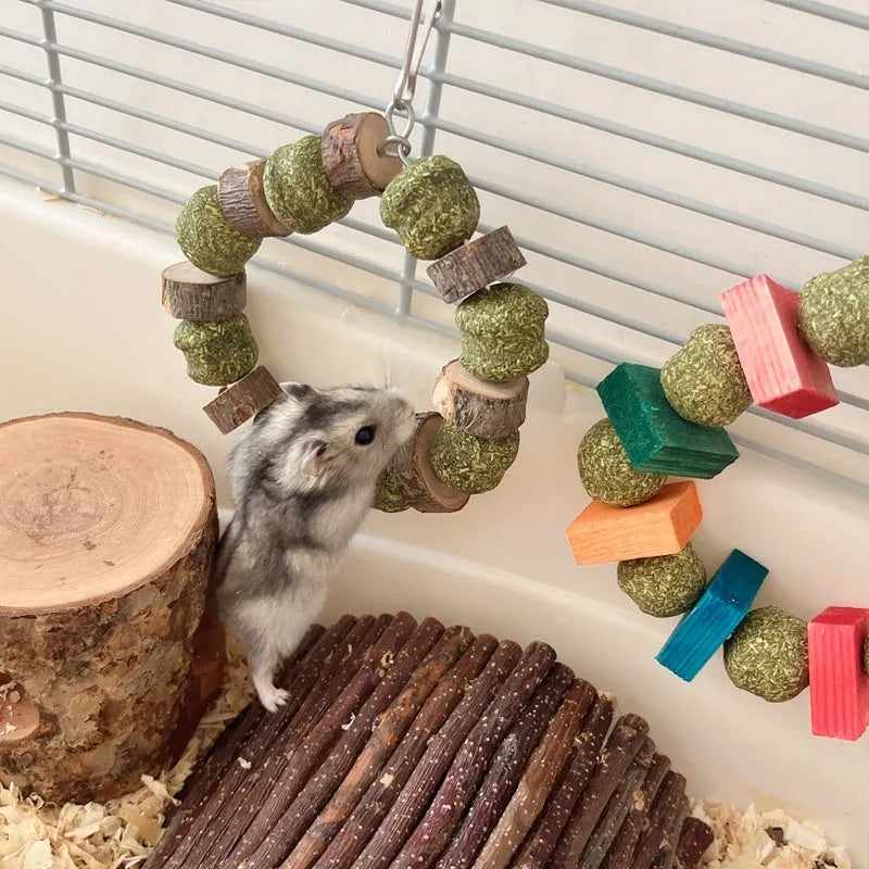 Hamster chew toy with applewood chewing surface and decorative straw ball ring