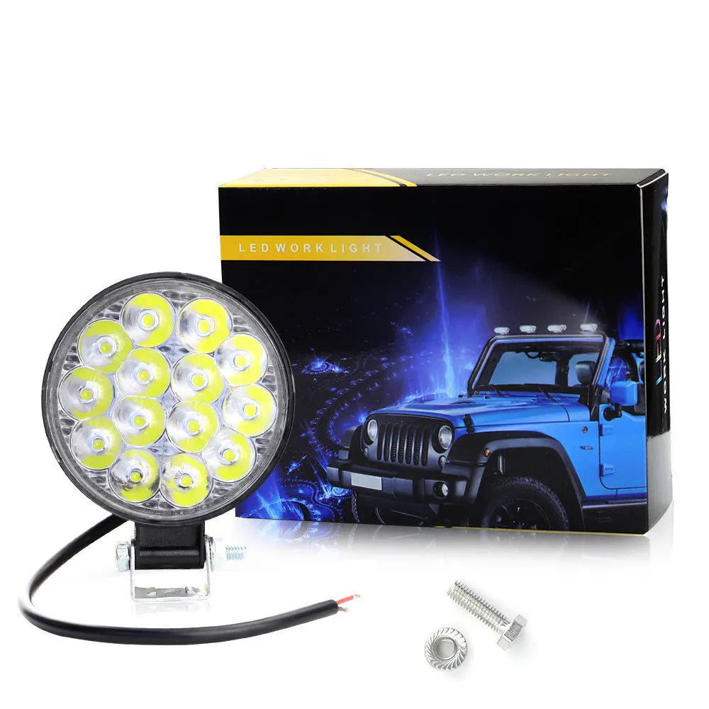 Mini round aluminium car LED work light with white light, shown for off-road vehicle installation.