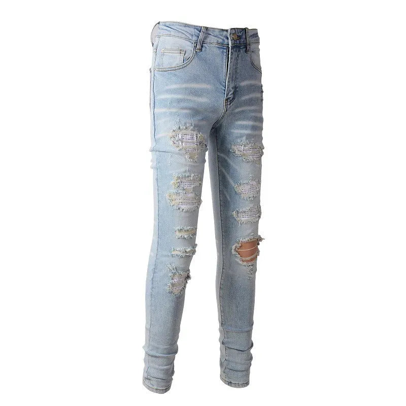 Light blue men's elastic slim fit jeans with hot diamond patch and whisker scrape detailing