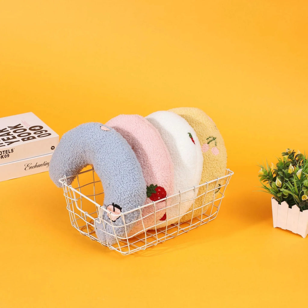 Half moon U-shaped cloth pillow for cats in blue, pink, white, and yellow colour options.