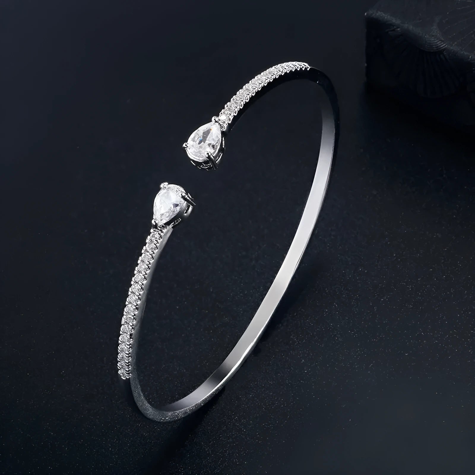Copper bracelet with inlaid zircon stones in a simple design, shown in white and blue colour options.