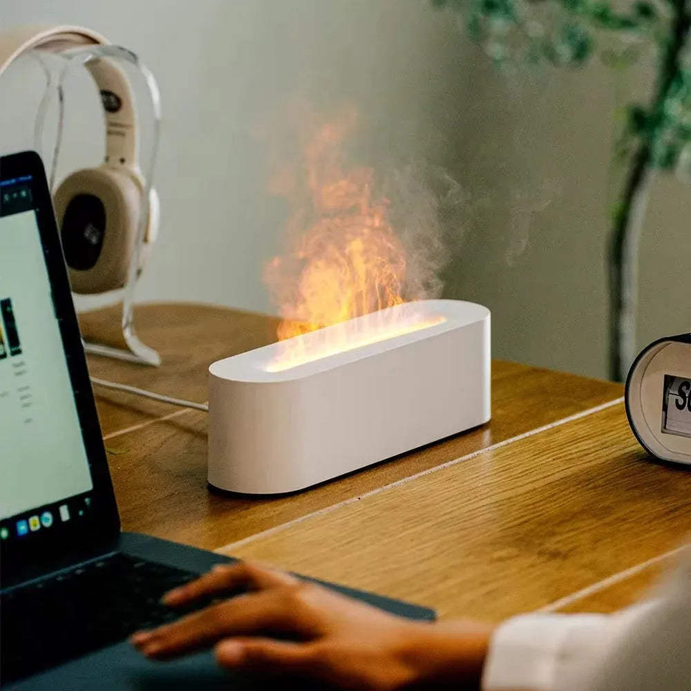Square black creative lava USB humidifier and aroma diffuser with colourful LED flame lighting on a desk.