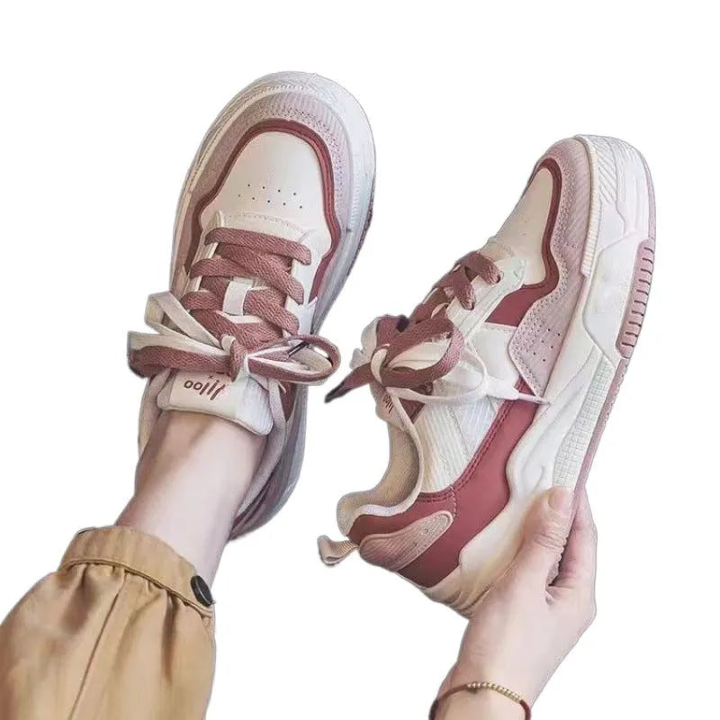 Beige and pink women's low top sneakers with a height increasing sole.
