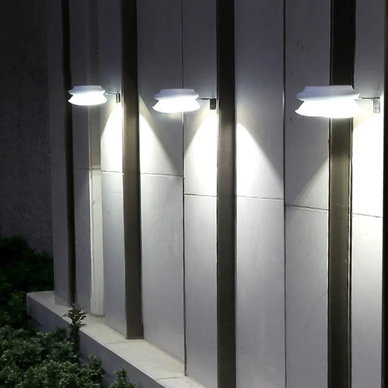 Solar-powered outdoor fence wall lamp in garden setting with 9 LED illumination