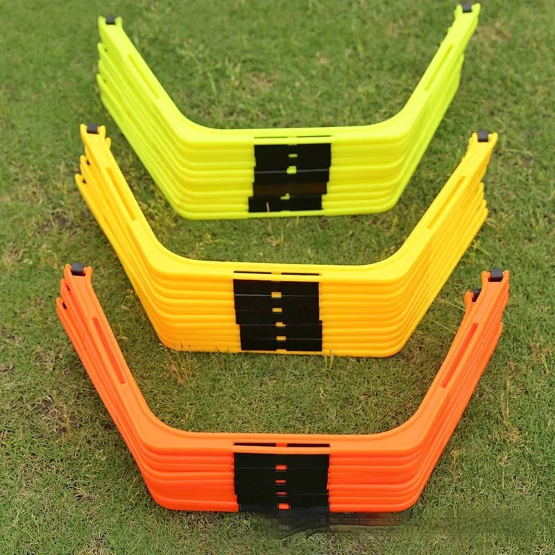 Set of six foldable yellow, green, and orange hexagon football agility training rings on grass