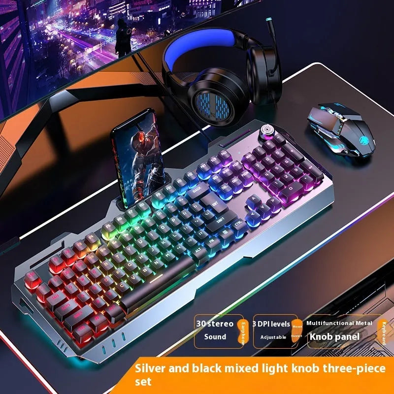 Aluminium mechanical gaming keyboard with rotary knob, shown in metal grey with rainbow backlighting.