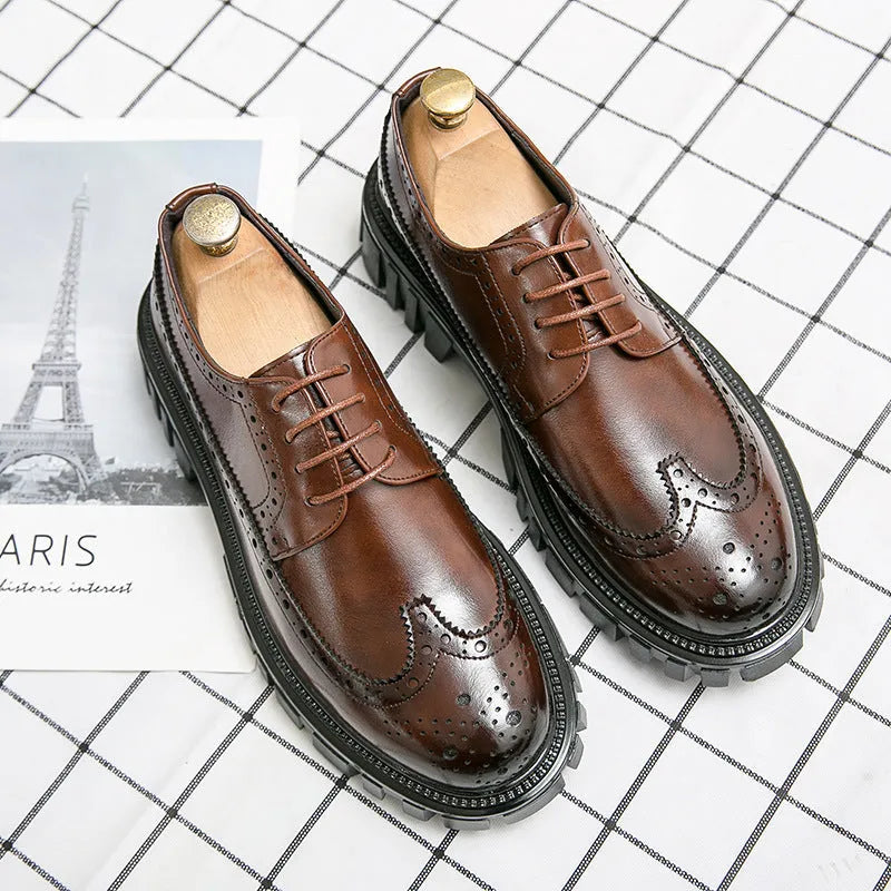 Men's black leather brogue shoes with round toe design on solid background