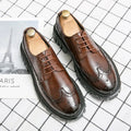 Men's black leather brogue shoes with round toe design on solid background