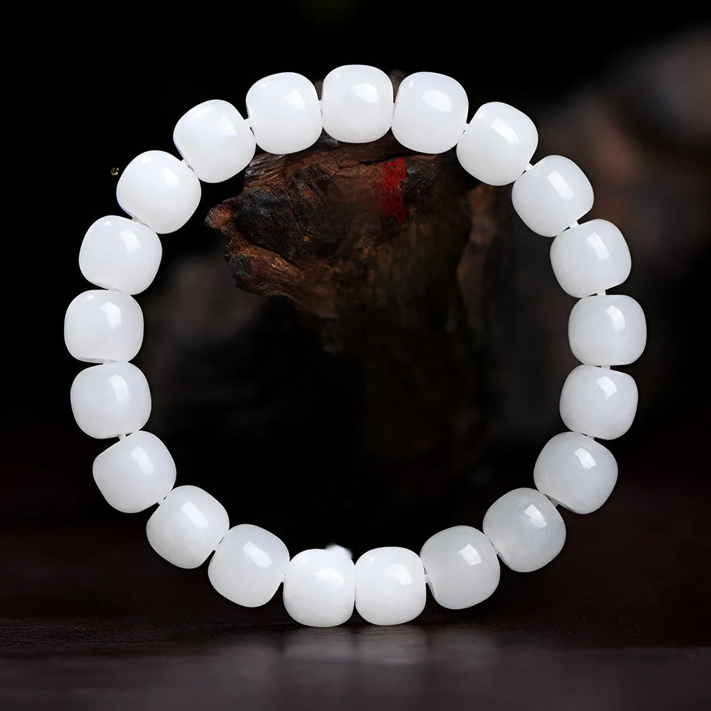 White Hetian jade barrel beads bracelet laid flat, showing unisex design and bead detail.