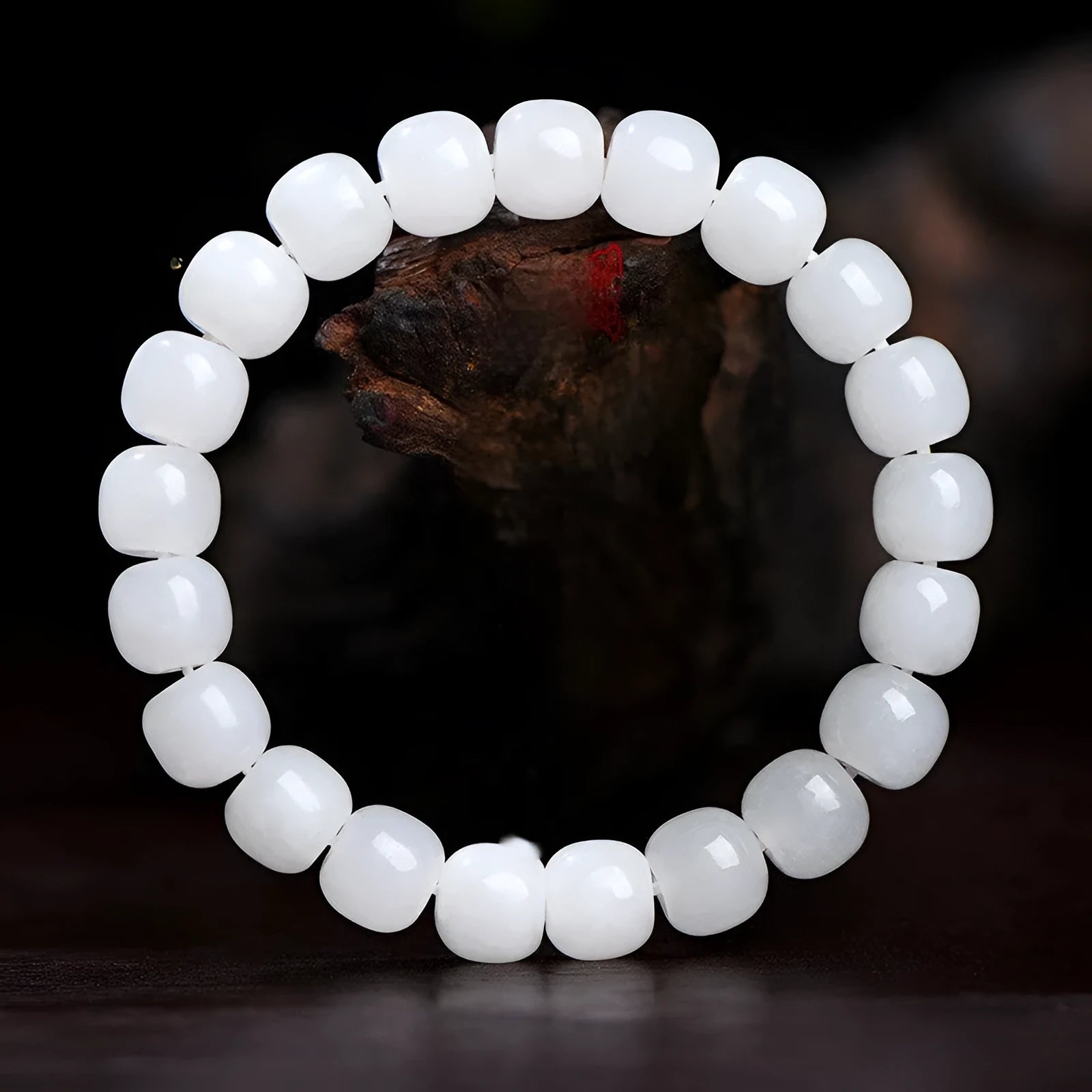 White Hetian jade barrel beads bracelet laid flat, showing unisex design and bead detail.
