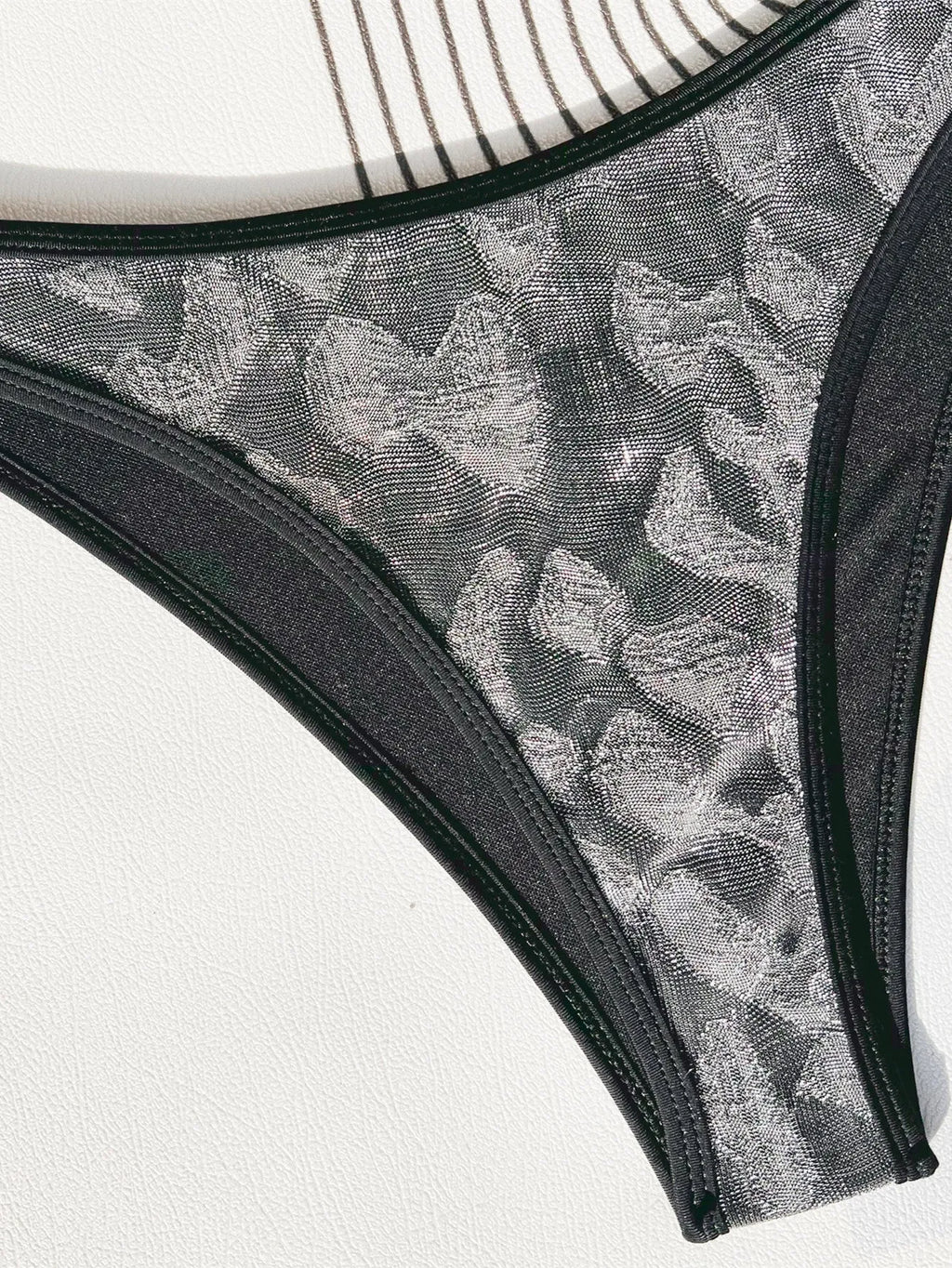 Ladies black polyester bikini swimsuit set with adjustable straps.