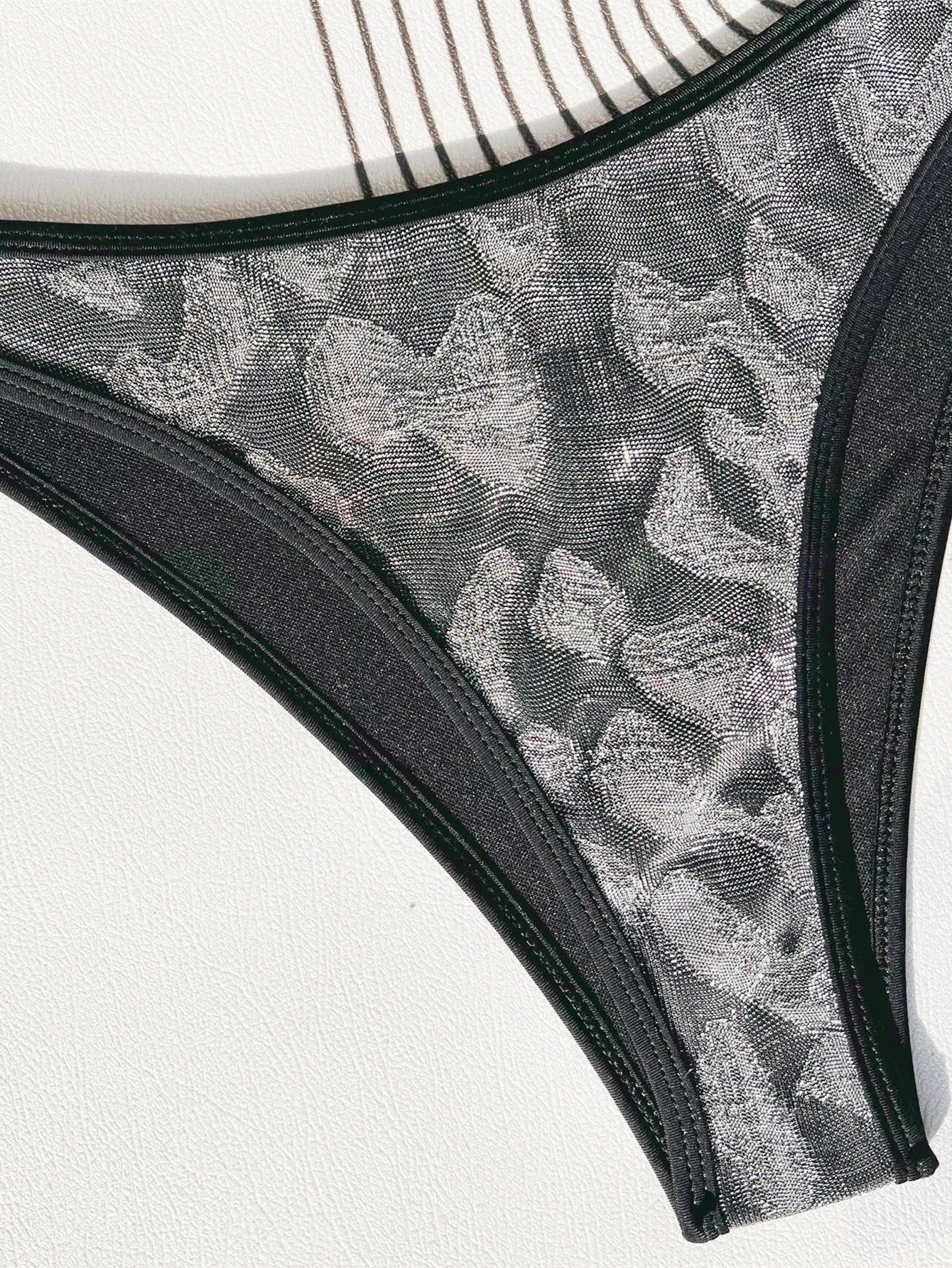 Ladies black polyester bikini swimsuit set with adjustable straps.