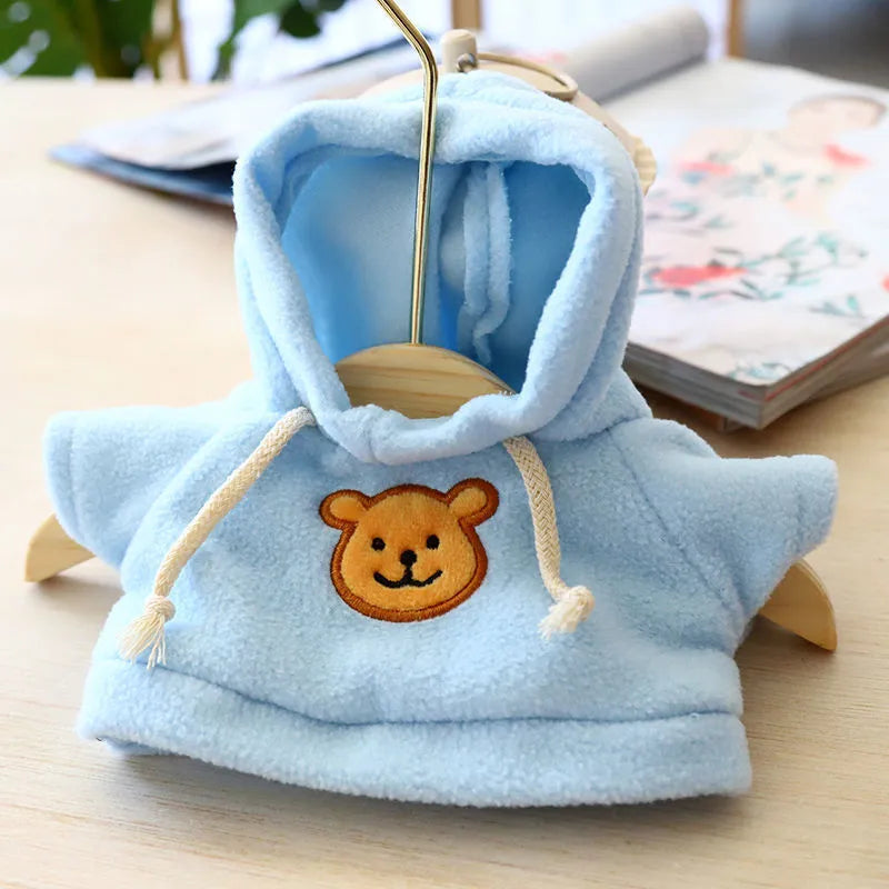 A dog wearing a blue cloth hoodie sweater, showing the casual hoodie style.