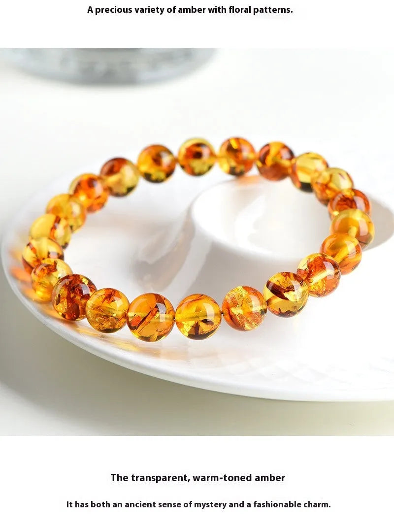 A geometric bead bracelet made from natural yellow piebald amber with flower spot patterning.