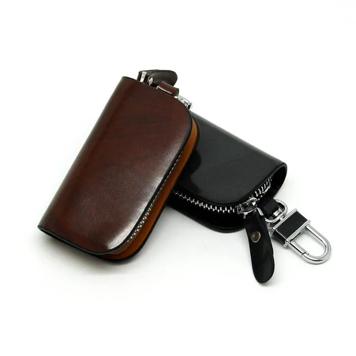 Black genuine leather car key case with a silver V-shaped zipper closed.