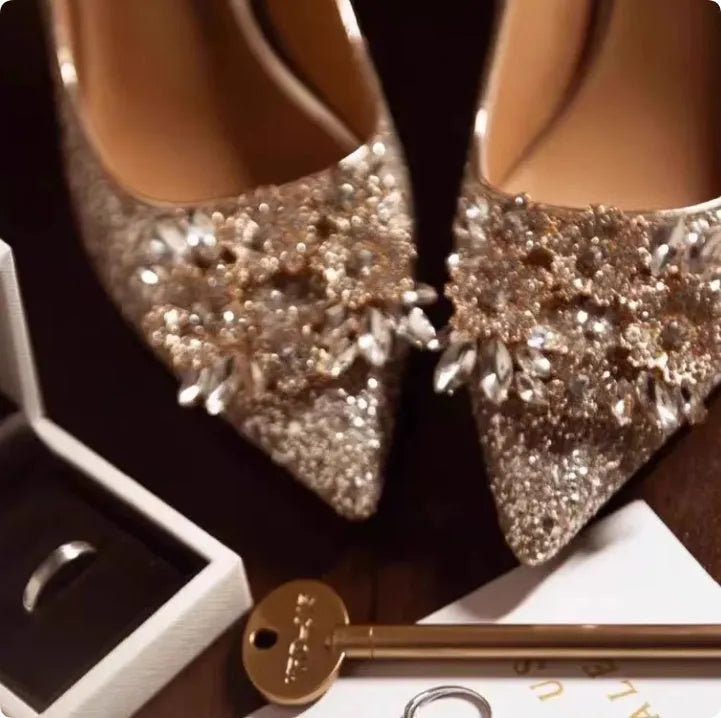 Champagne coloured pointed toe bridal shoes with rhinestone decoration on a fine heel.