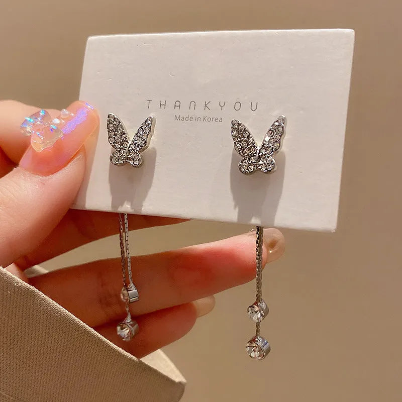 Silver alloy butterfly tassel earrings with geometric design, fresh style, on white background