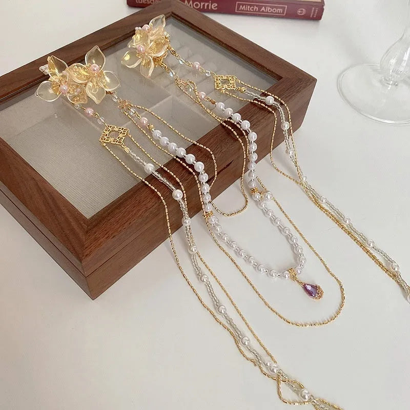 Gold grip hairpin with white pearl diamond flower and long clear tassel decoration.