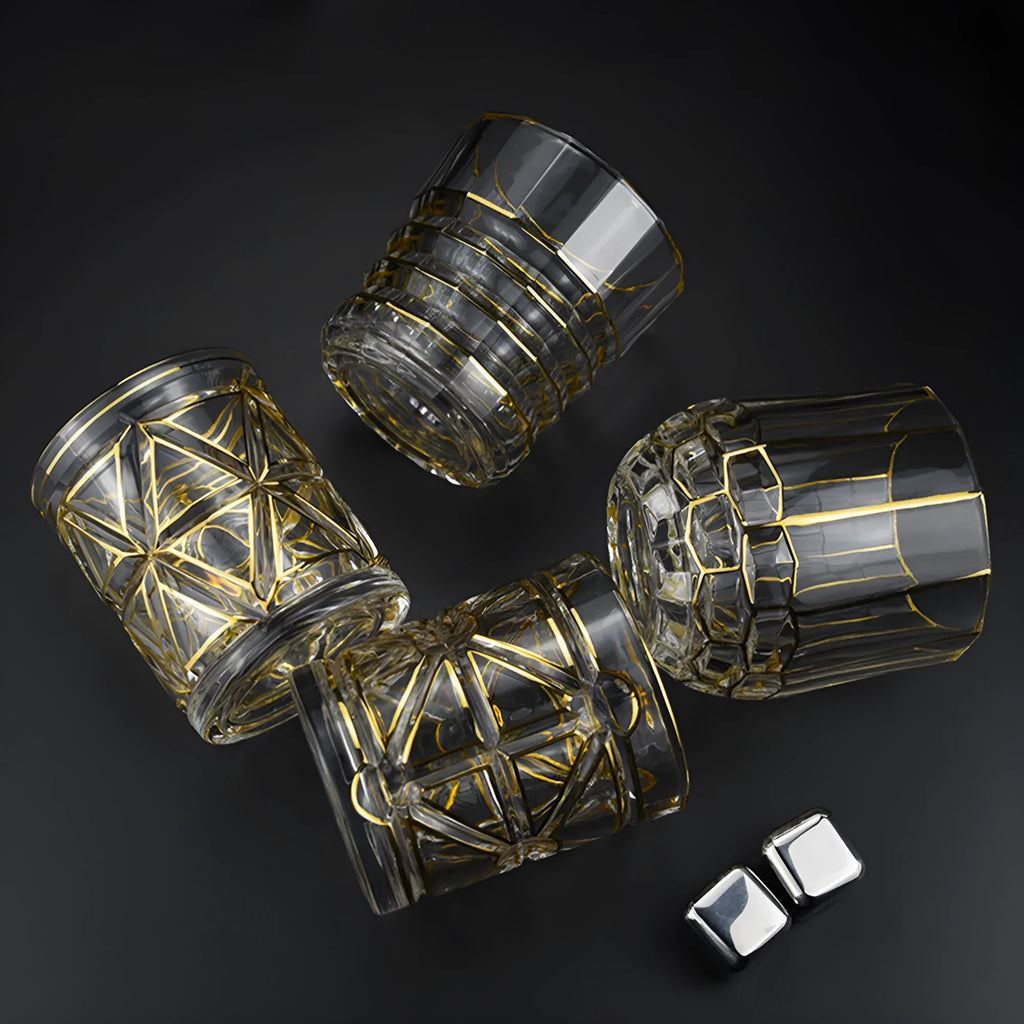 Crystal glass whiskey shot glass with solid gold finish on a bar counter
