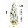 Small 24 inch white Christmas tree with built-in lights and simulated snow sprayer effect on branches