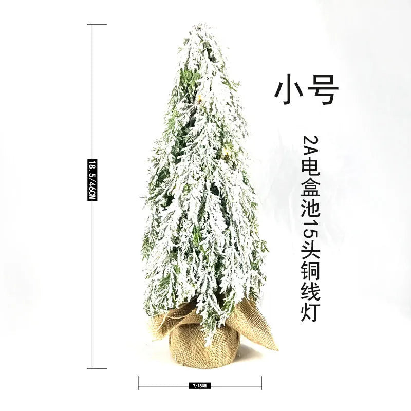 Small 24 inch white Christmas tree with built-in lights and simulated snow sprayer effect on branches
