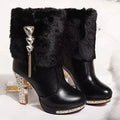 Women's black ankle boot with a chunky high heel on a white background.