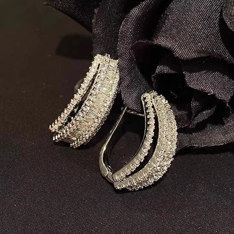 Women's geometric zircon stud earrings with white gold colour plating.