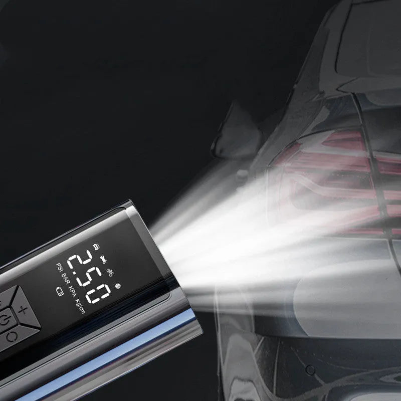 Portable wireless digital car tyre pump with display, hose, and cables on a grey background.