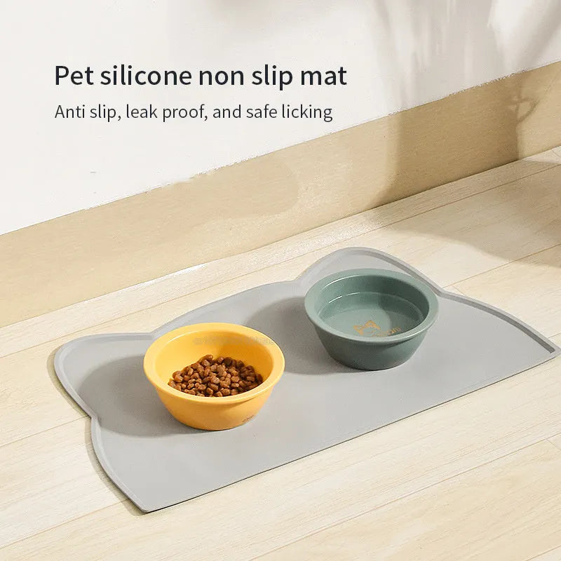 Solid colour silicone pet feeding mat placed under dog bowl on floor