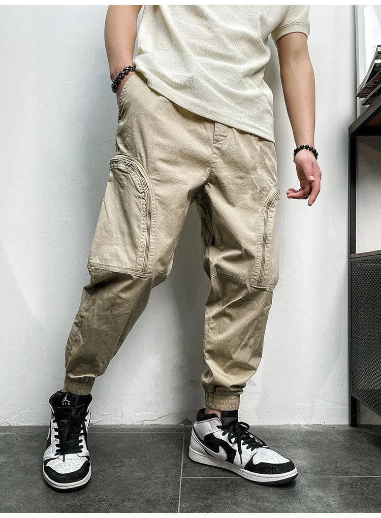 Men's loose-fit cotton cargo trousers with elastic waist, zipper, and multiple big pockets in army green
