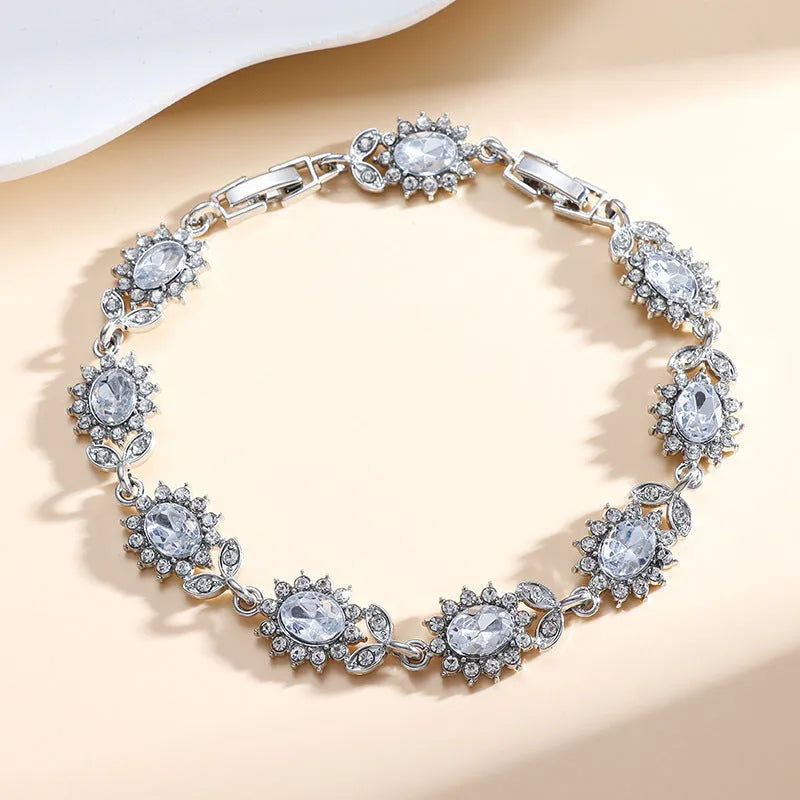 Women's bracelet with coloured zircon stone inlays in environmentally friendly alloy with electroplated finish