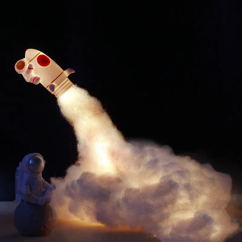 DIY astronaut rocket night light kit with warm LED string lights, plastic chassis, and straws for assembly.