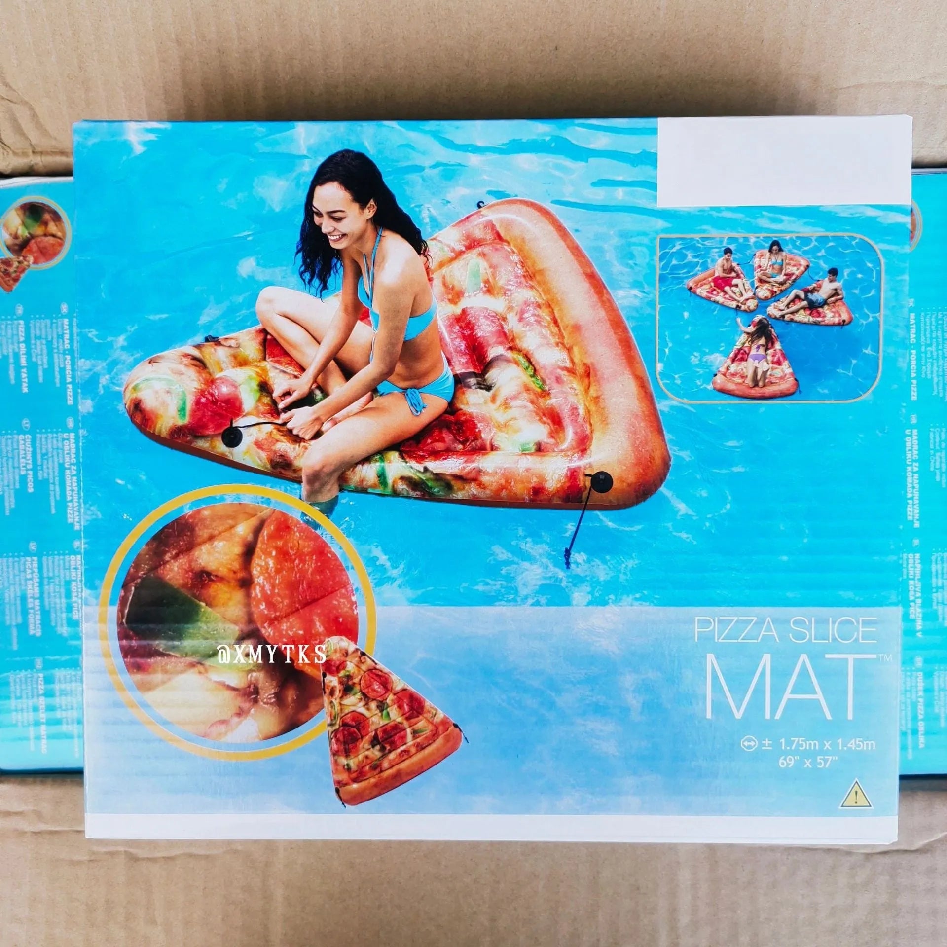 Pizza slice shaped inflatable surfboard recliner floating on water with colourful graphic design