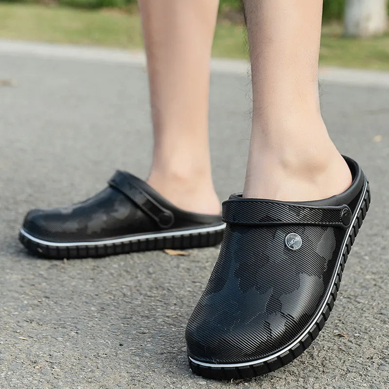 Men's casual beach sandals in black with flat heel, round toe, and EVA upper on a wooden floor
