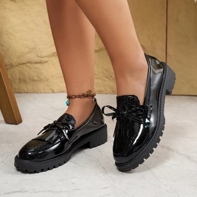 Women's black and brown casual loafers with a decorative bow on the artificial PU upper.