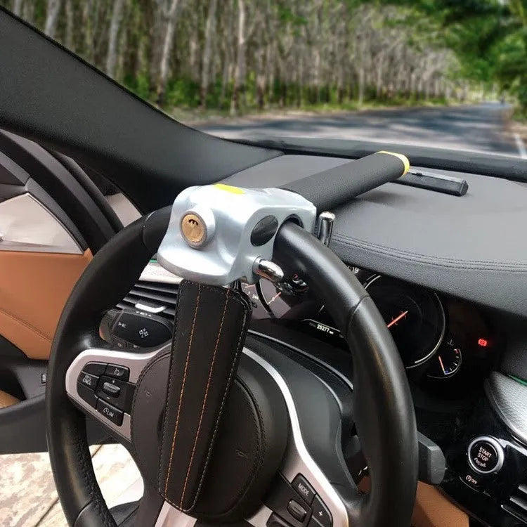 Universal car steering wheel lock with alarm in black gold finish on vehicle steering wheel