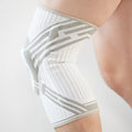 A blue high elasticity cotton knee pad shown on a knee, suitable for basketball and running sports.