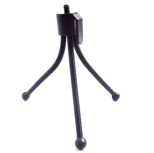 Small aluminium folding tripod with ball head mounted with smartphone on desktop