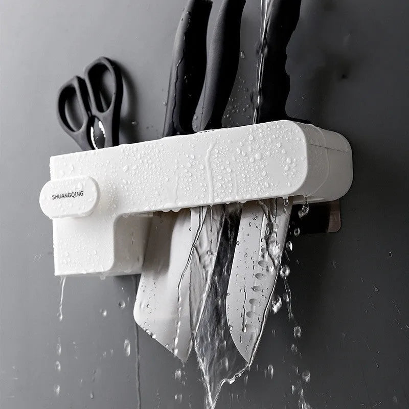 White plastic kitchen knife rack with modern simple design on countertop holding several knives