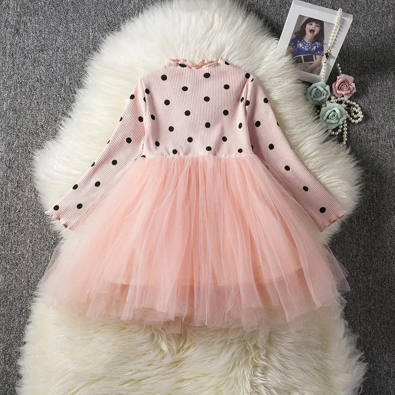 A baby girl's long sleeve black tutu dress with lace detail, suitable for birthdays and christenings.