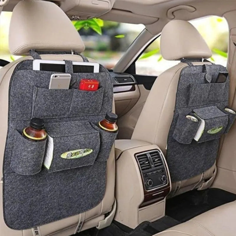 Multi-purpose auto seat organizer bag in black waterproof fabric with multiple pockets on a car seat