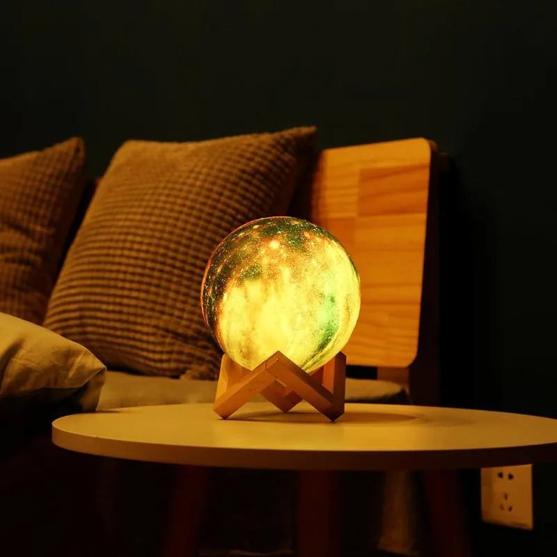 3D printed spherical moon lamp glowing on a surface, showing its textured lunar surface and soft LED light.